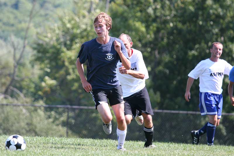 Mike Girard races Don Phillips as a teammate watches.