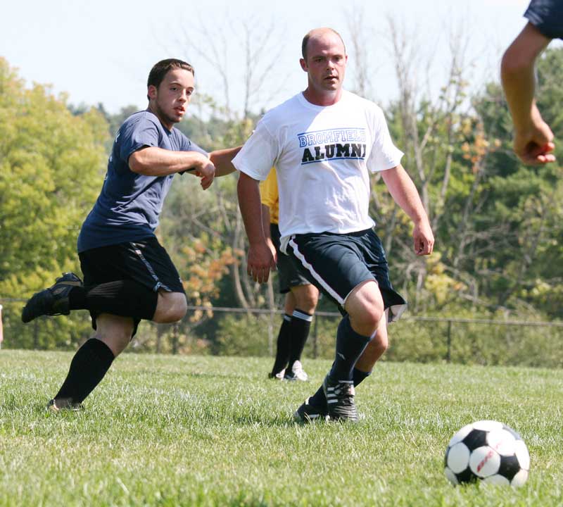 Nick Kimball and alum Adam Mara eye the ball.