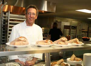 Chef Paul Correnty serves freshly prepared sweet and sour chicken and vegetable wraps in the Bromfield kitchen. (Photo by Lisa Aciukewicz)