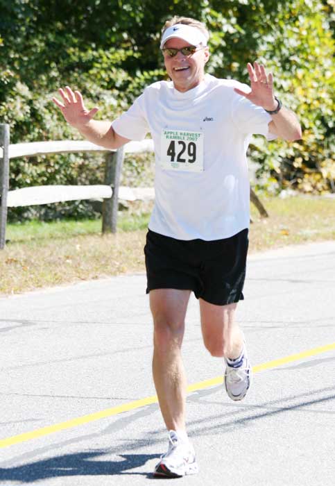 Tom Daniels of West Bare Hill Road still runs with a smile at mile 8½.