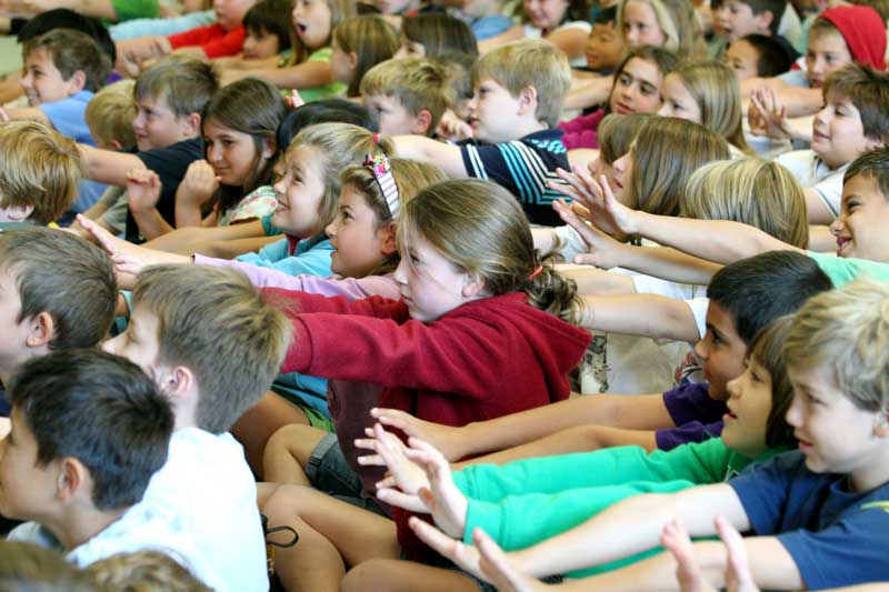 A group of third-graders stretch between stories.