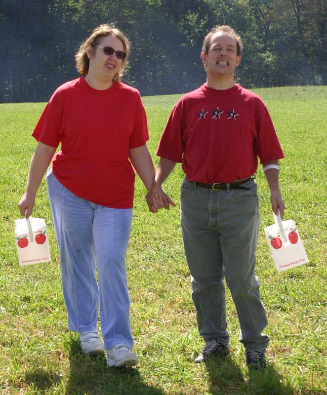 Leah Tulin and Wayne Curcci, truly best buddies, cross the meadow at Little Rascals Orchard.