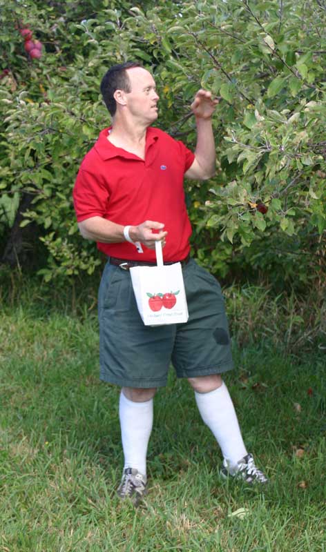 Joey Coleman, a participant in the Best Buddies program, fills a bag with apples. (Photo by Julie Moberly)