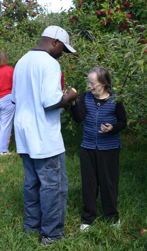 George Kizito of Cooperative for Human Services in Burlington helps Cheryl Woodis.