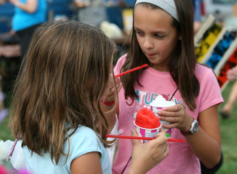 Eliza Agosta and Emma Keaney enjoy snow cones on a warmer-than-average Columbus Day weekend.