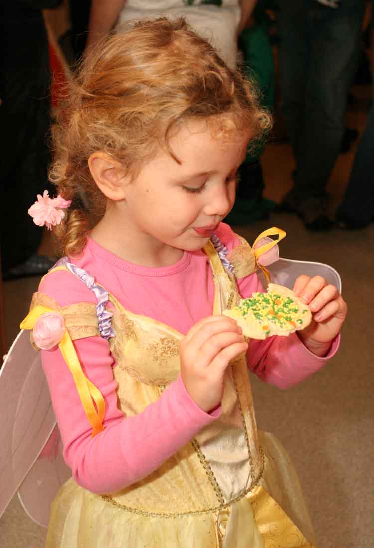 Three-year-old Sarah Peterson, granddaughter of John and Gail Ownings, enjoys a Halloween cookie.