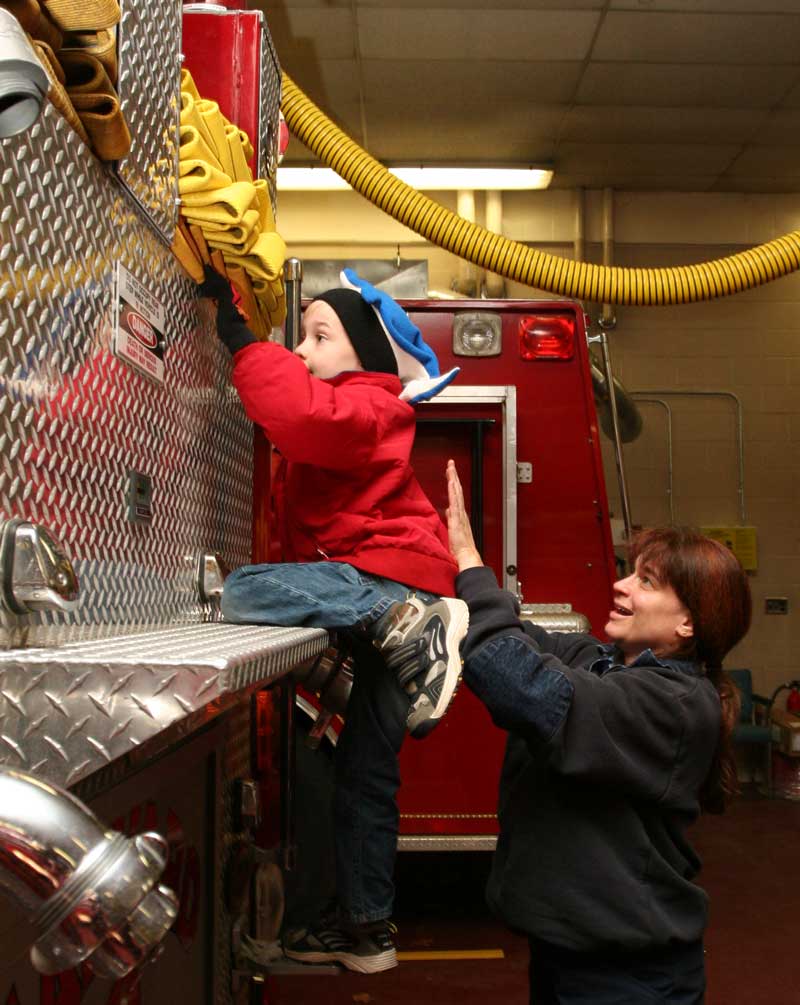 Will Squire gets a helping hand from firefighter Oona Aldrich. (Photos by Lisa Aciukewicz) Will Squire gets a helping hand from firefighter Oona Aldrich. (Photos by Lisa Aciukewicz)