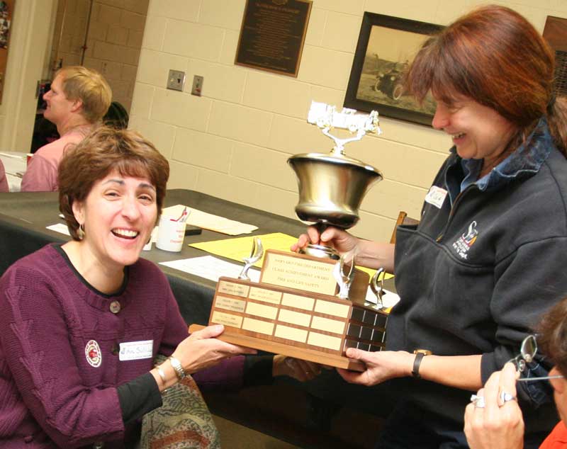 Third-grade teacher Arlene Sullivan accepts a trophy for the class with the most entries from Oona Aldrich. Third-grade teacher Arlene Sullivan accepts a trophy for the class with the most entries from Oona Aldrich.