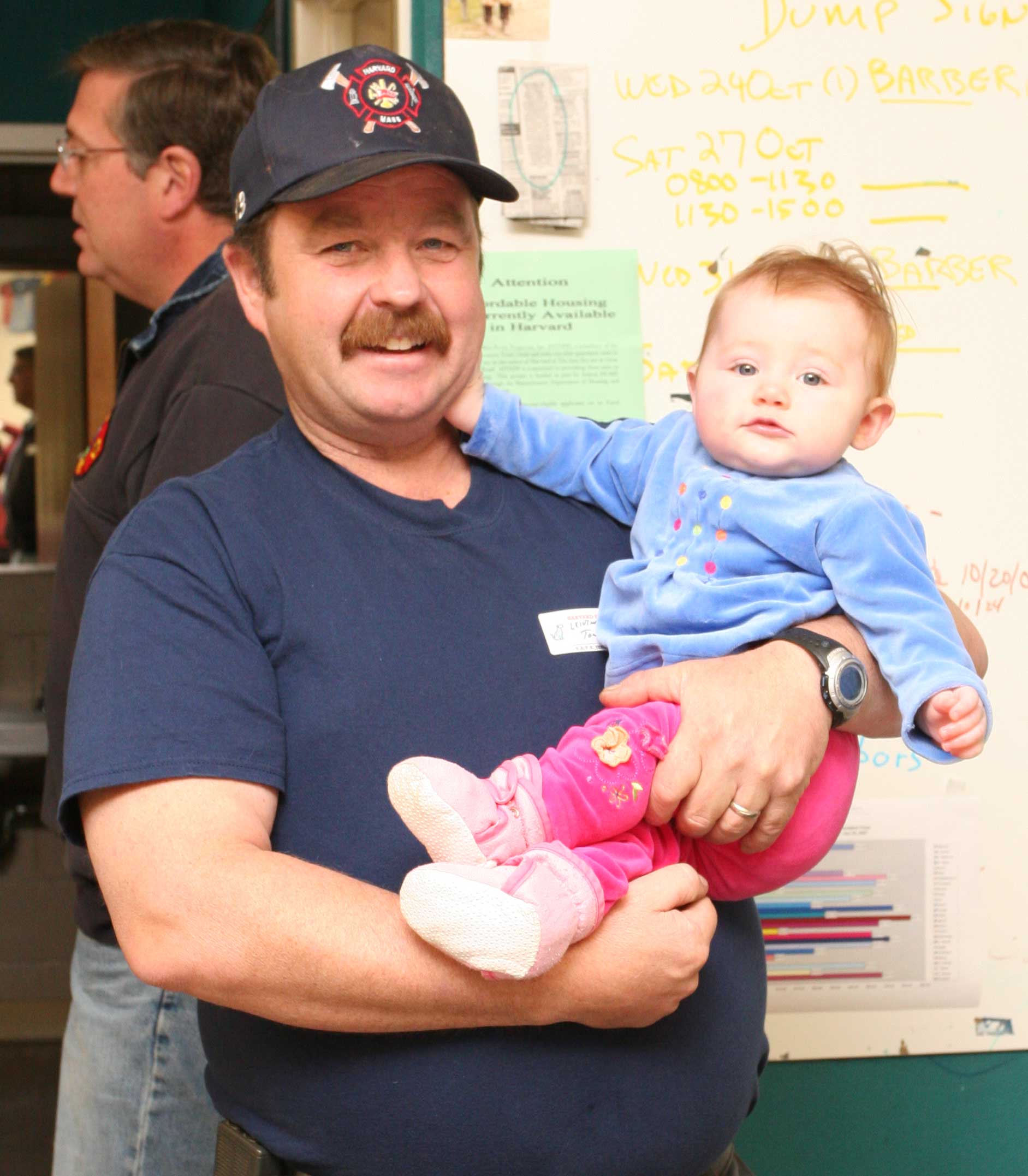 Firefighter Tony Shaw holds baby Emma Squire so her parents can eat their pancakes. Firefighter Tony Shaw holds baby Emma Squire so her parents can eat their pancakes.