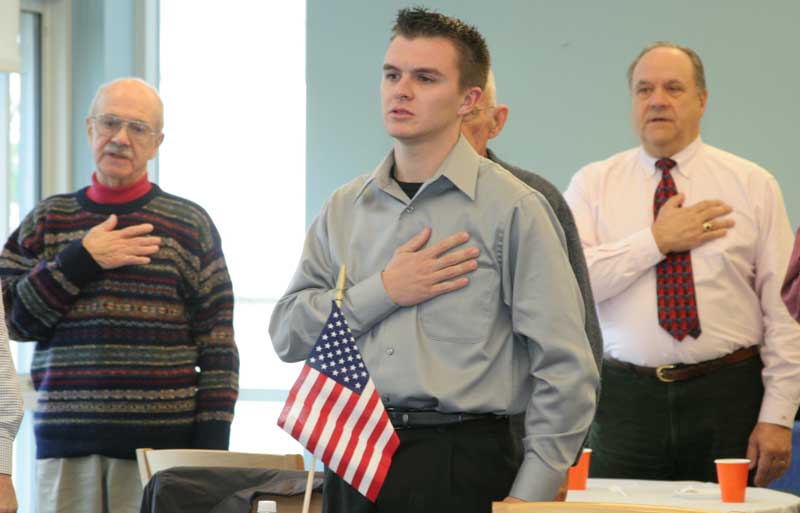 From left: Veterans Jim DeZutter, Jonathan Blinn, and Joe Theriault recite the Pledge of Allegiance  at a Veterans Day breakfast at Bromfield.