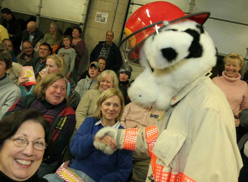 Debbie Garfield (left) and Debbie Ricci make the aquaintance of Sparky the fire dog. 