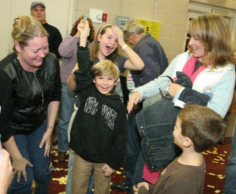 Alex Lee (center) holds up his door-prize-winning ticket as (from left) Donna Lee, Veronica Lee, Sherry Armstrong and Will Armstrong react.