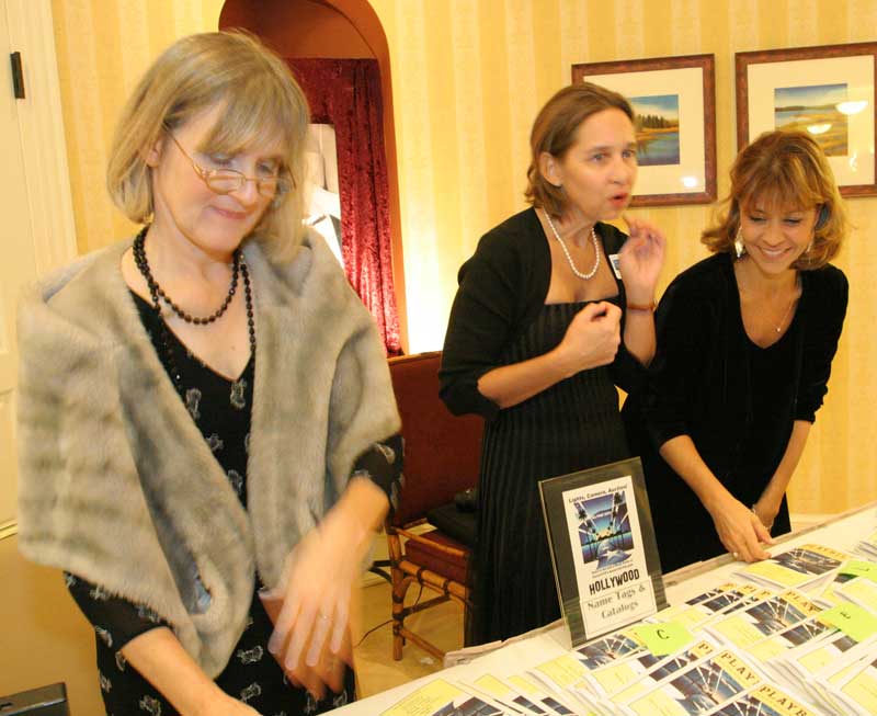 Fall fête volunteers Joan Eliyesil, Beth Drummey, and Cyndy Steeves greet guests.
