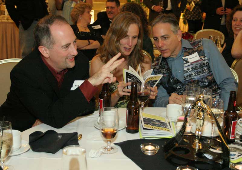 Rich Maiore, Virginia Justicz , and Bob Eiland check out auction items.