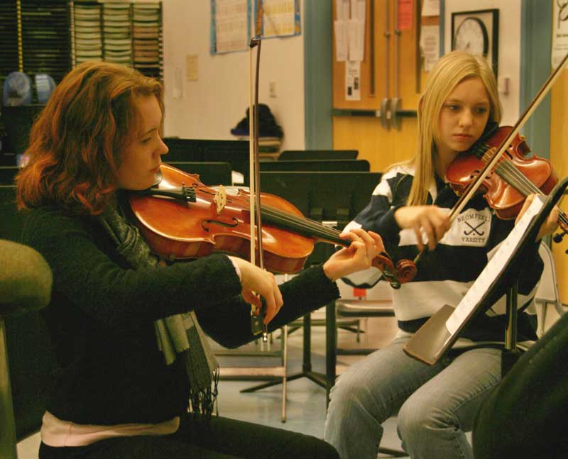 Kristina Kronauer, left, and Eva Keena rehearse for Saturday’s concert at the library. (Courtesy photo by Elizabeth Frothingham)