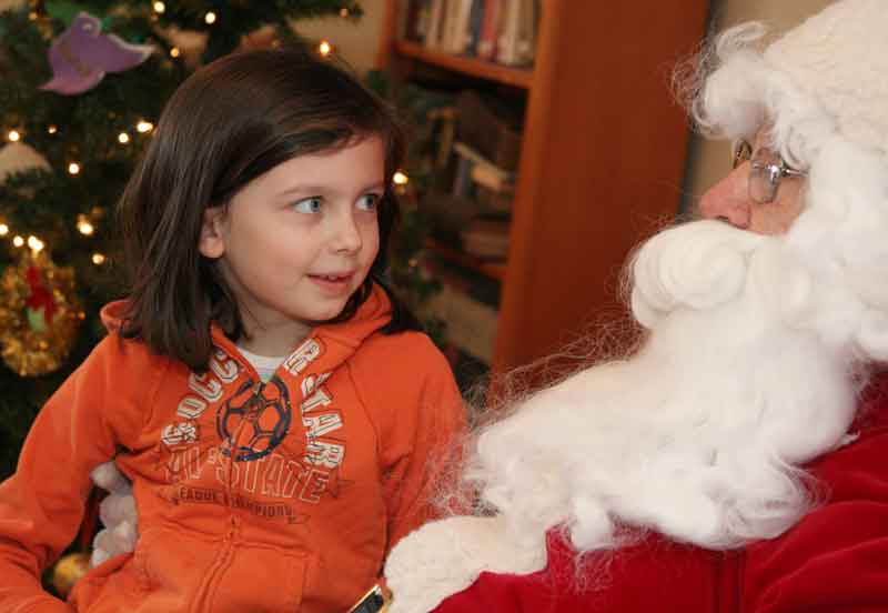 Isabel Barton sits on Santa's knee.