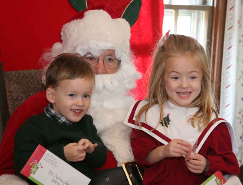 Liam and Fiona Morrison are all smiles sitting on Santa's lap.