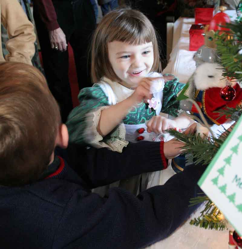 Bridgette Kennedy puts her finger in the mouth of a hungry nutcraker at the Congregational Church Christmas Fair.