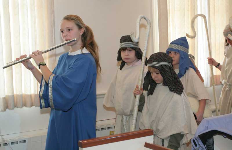Kara Kennedy, on flute, leads shepherds Johnny Bakis, Cory DeGuglielmo, and Scott Jarosz.
