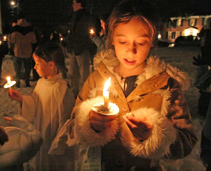 Emily Ferguson plays with wax as she takes part in the tree lighting festivities on the Common.