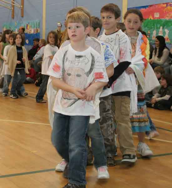 Mitch Sampson, Jack Armstrong, and Pilar Vellante lead the canoe dance.