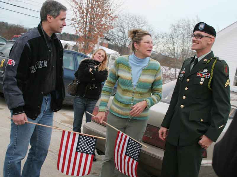 Looking more than a little surprised, Corporal McClure is greeted by Tom (left) and Ramae Phillipou (second from right) as friend Serena Ryan (center) looks on after she retrieved him from the airport.