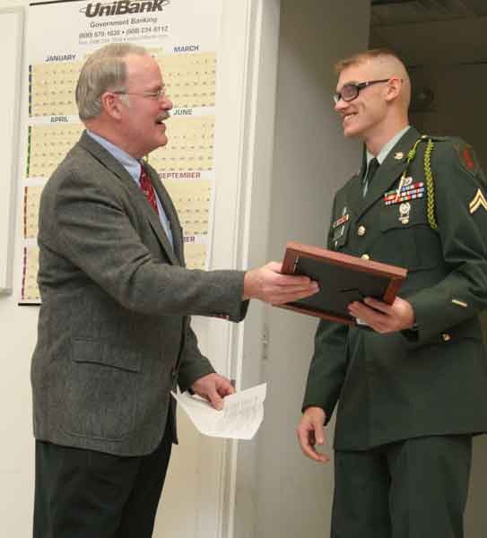 Selectman Bob Eubank presents Corporal McClure with a commendation.