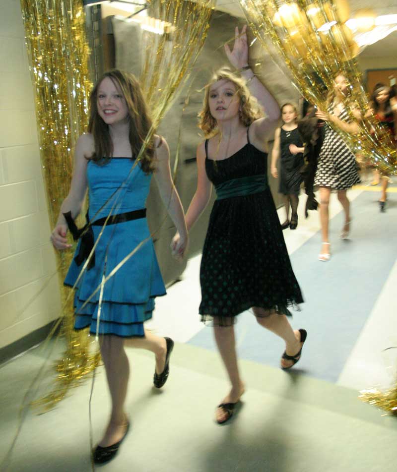 Hannah Egan and Miranda DeGuglielmo enter the transformed cafeteria for the Snowflake Dance.