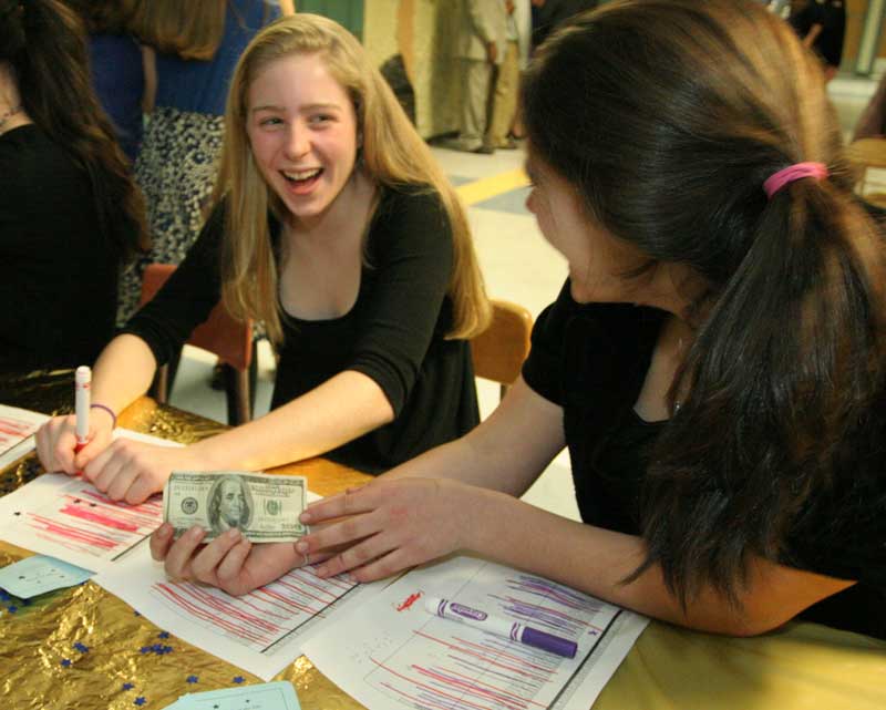 Sarah Collins and Molly O’Rourke-Friel react to receiving a $100 bill for admission at the Snowflake.