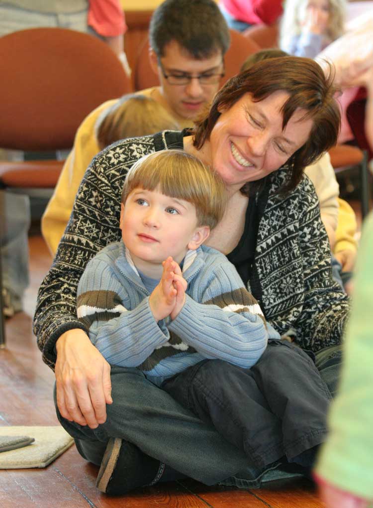 Charlotte Winchell enjoys the show with son Dylan on her lap.