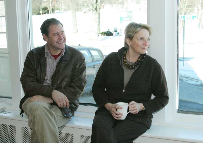 Owners Adam and Lyn Horowitz relax on the bench in front of the thermal-paned windows lining the front of the newly renovated General Store. (Photo by Lisa Aciukewicz)