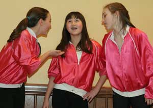 Pink ladies Emma Hall, Julia Nelson, and Casey McGrath peform a scene from Grease. (Photo by Lisa Aciukewicz)