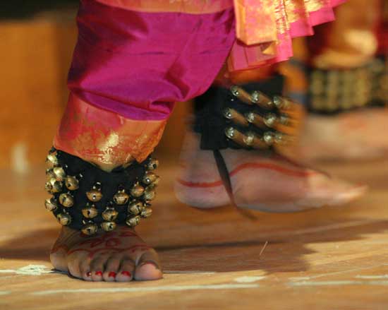 A dancer’s feet are decorated with henna and send the sound of bells throughout the performance.