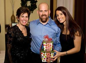 Sweet Boutique owner Sue George with Kevin Youkilis, holding gift boxes from Harvard Sweet Boutique, and Enza Sambataro, his fiancée and president of “Kevin Youkilis Hits for Kids." (Courtesy photo by Michael Blanchard) Sweet Boutique owner Sue George with Kevin Youkilis, holding gift boxes from Harvard Sweet Boutique, and Enza Sambataro, his fiancée and president of “Kevin Youkilis Hits for Kids." (Courtesy photo by Michael Blanchard)