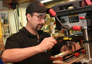 Chris Niedzinski works on a drill press in his basement fishing lure assembly shop. (Photo by Lisa Aciukewicz) Chris Niedzinski works on a drill press in his basement fishing lure assembly shop. (Photo by Lisa Aciukewicz)