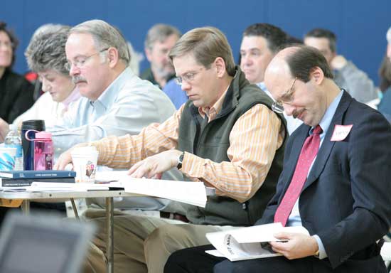 Left to right: Selectmen Lucy Wallace, Bob Eubank, and Tim Clark, and Town Counsel Mark Lanza study the warrant.