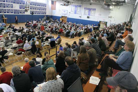 Residents sit in the Bromfield gym listening to this year's burning issues at last Saturday's Town Meeting. The meeting ran until 6 p.m. to get through all 33 articles on the warrant. 