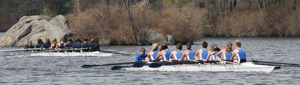 The girls varsity 8 boat pulls ahead of Duxbury during a race on Bare Hill Pond last Saturday. (Photo by Lisa Aciukewicz)