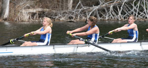The stroke, Robin Neschke, Maggie Cochrane, and Ally Cohen pull across the finish line in the girls varsity 8 race. (Photo by Lisa Aciukewicz)