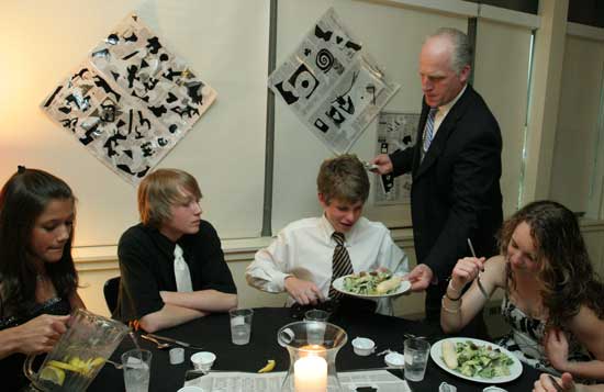 Principal Jim O’Shea serves dinner to Sarah Andrews, Declan Dean, Taylor LeBlanc, and Anna Hadorn.