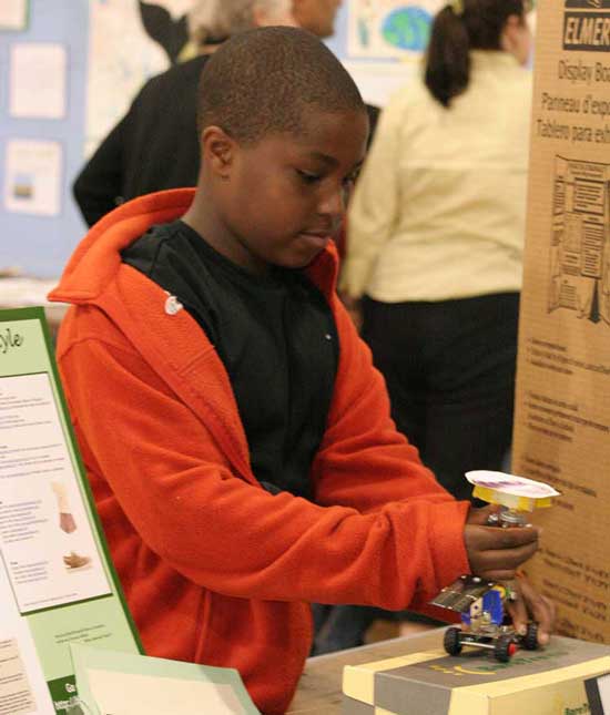 Henry Porte plays with a solar-powered car at the Earth Day fair at the elementary school last Thursday.