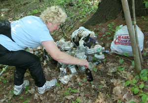 Christine Spielvogel sorts through a pile of trash picked up along a quarter-mile section of Pinnacle Road. She bags the trash and later picks it up on her way to the transfer station. (Photo by Lisa Aciukewicz) Christine Spielvogel sorts through a pile of trash picked up along a quarter-mile section of Pinnacle Road. She bags the trash and later picks it up on her way to the transfer station. (Photo by Lisa Aciukewicz)