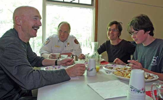 Enjoying the Memorial Day pancake breakfast, Geoff Koetsch, Fire Chief Bob Mignard, Liz Rotter and Nico Koetsch discuss Nico’s plan to have dinner in Tokyo, thanks to his prize-winning duck in the Ducky Wucky race.