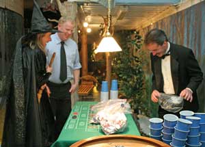 Wicked witch of the west Patty Wenger, Larry Miller, and Dennis Bradley set up for the casino.