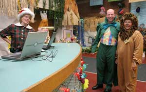Dressed as residents of Oz, (left to right) Tammy Wilkinson, Michael Krutz, and Lois Krutz greet visitors to the Celebration’s open house at Bromfield before prom-goers arrive.