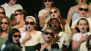 The chorus dons their shades to sing “Sixteen Tons.”