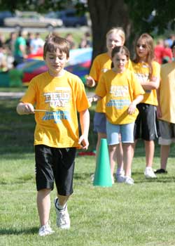 Mitchell Mandozzi carefully balances an egg on a spoon while taking part in a relay race.