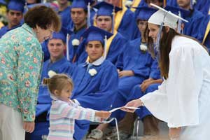 Jane Venditti and Faith Massoni give the Vilage Nursery School award to Jamie Ryan.
