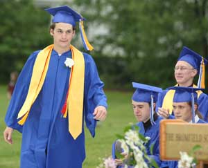 Valedictorian Danny Child approaches the podium to receive an award from the Bromfield Trustees. 