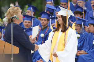 Terry Mead congratulates Casey Silver as she receives an award from the Harvard Lions Club